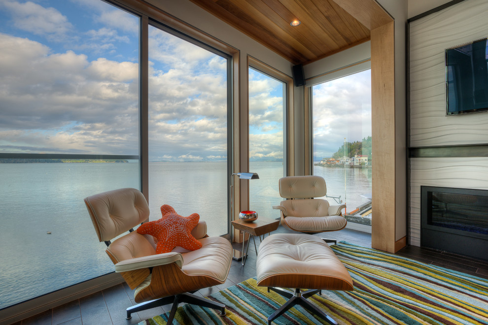 Example of a beach style open concept living room design in Seattle with white walls