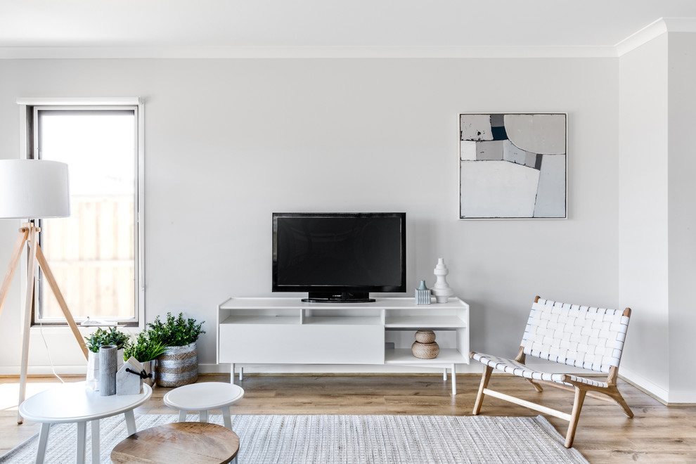 This is an example of a contemporary living room in Melbourne with grey walls, carpet and beige floors.