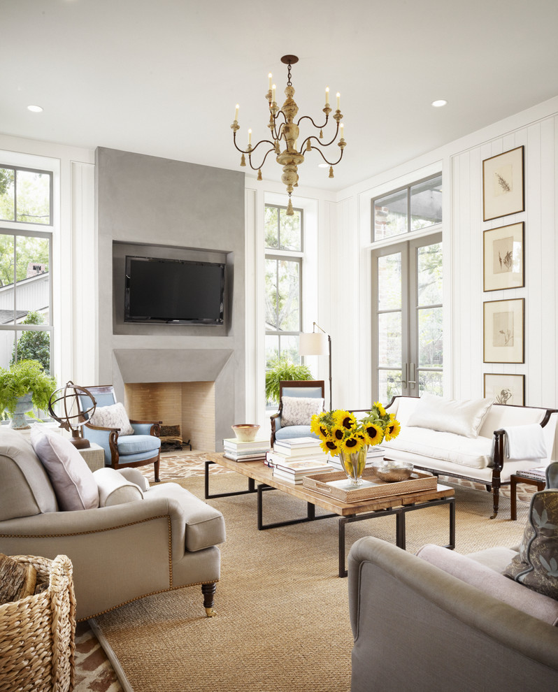 Example of a large farmhouse open concept brick floor living room design in Houston with white walls, a standard fireplace, a wall-mounted tv and a concrete fireplace