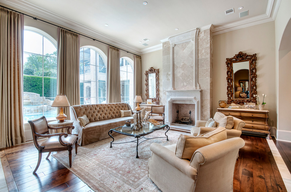 Inspiration for a huge mediterranean formal and enclosed dark wood floor living room remodel in Houston with beige walls, a standard fireplace, a stone fireplace and no tv