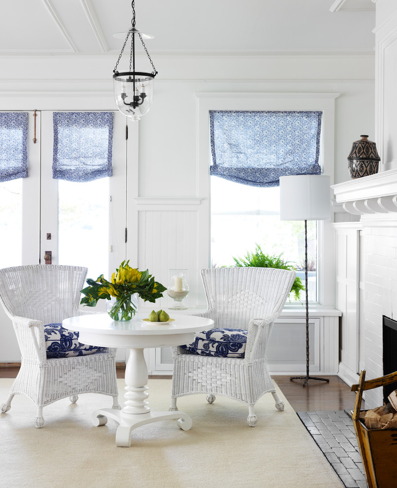 Beach style living room photo in Chicago with white walls, a standard fireplace and a brick fireplace
