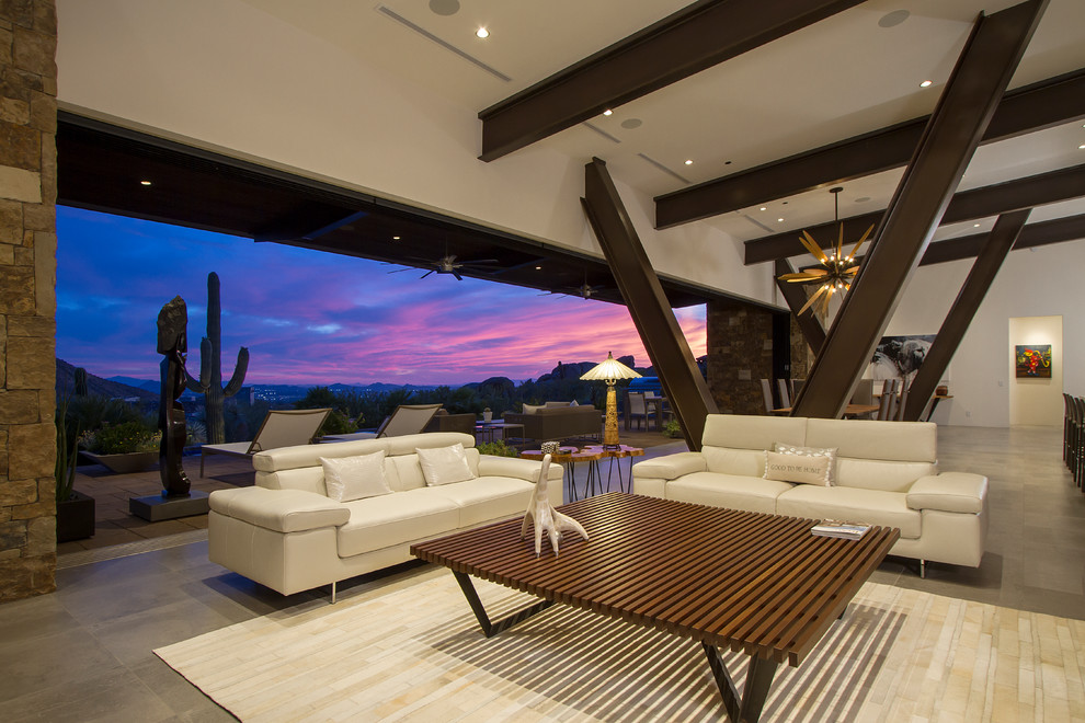 Contemporary open plan living room in Phoenix with grey floors.