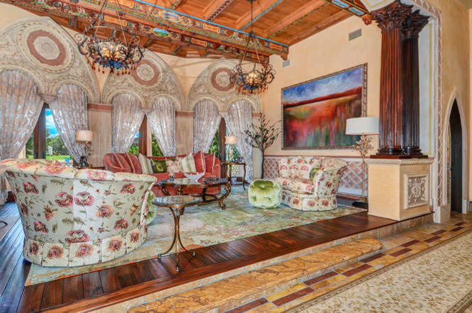 Photo of a large mediterranean formal open plan living room in Tampa with beige walls, dark hardwood flooring, a standard fireplace, a stone fireplace surround, no tv and brown floors.