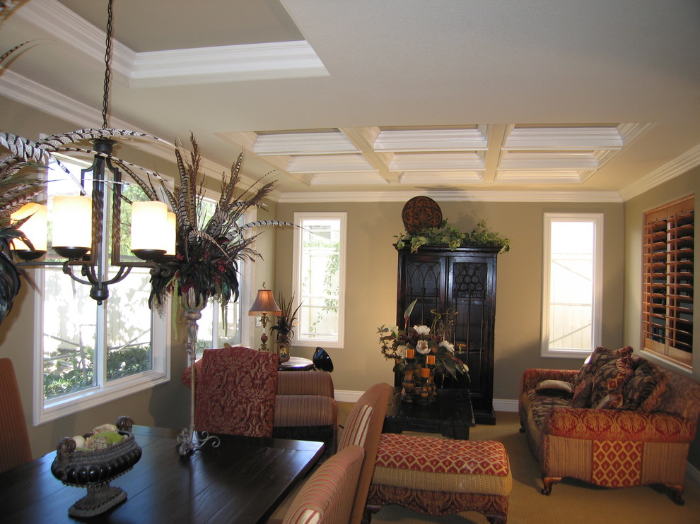 This is an example of a large classic living room in Orange County with green walls.