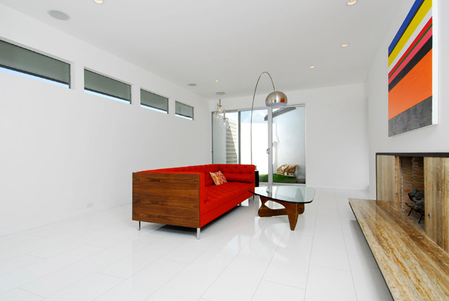 Cette image montre un salon design de taille moyenne et fermé avec un mur blanc, un sol en linoléum, une cheminée standard et un manteau de cheminée en bois.