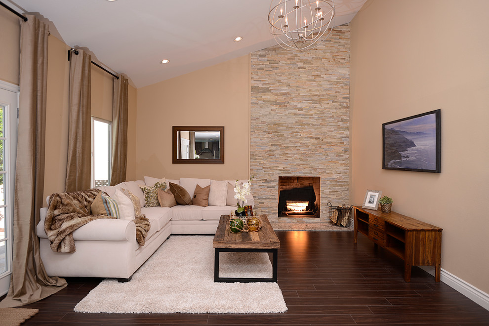 Inspiration for a contemporary formal living room in Orange County with beige walls, dark hardwood flooring, a standard fireplace, a stone fireplace surround and a wall mounted tv.