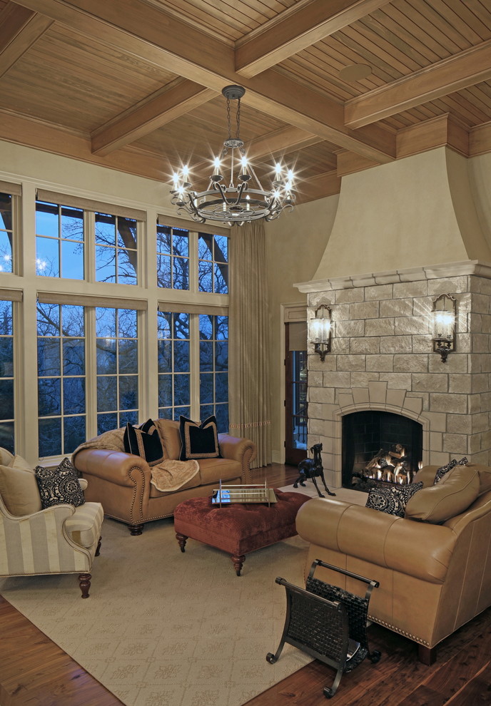 Living room - huge traditional open concept medium tone wood floor living room idea in Omaha with beige walls, a standard fireplace and a stone fireplace