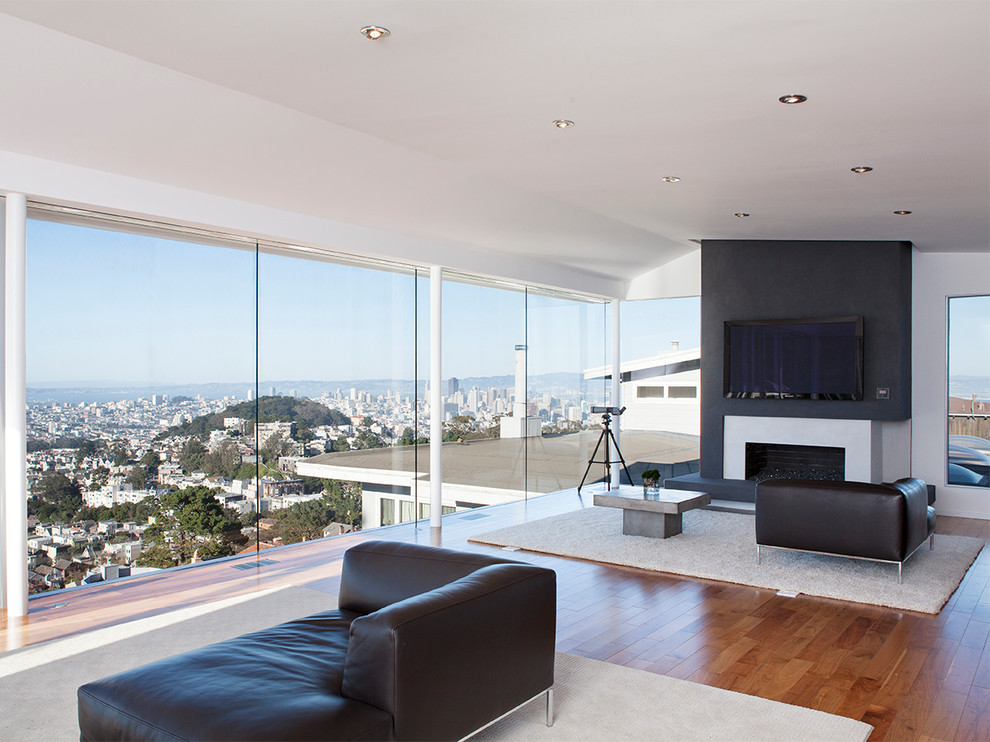 Idee per un soggiorno design aperto con camino classico e TV a parete