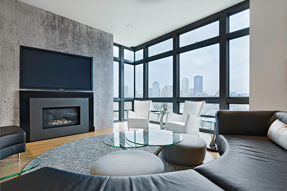 Example of a mid-sized minimalist loft-style light wood floor living room design in Other with white walls, a standard fireplace, a metal fireplace and a wall-mounted tv