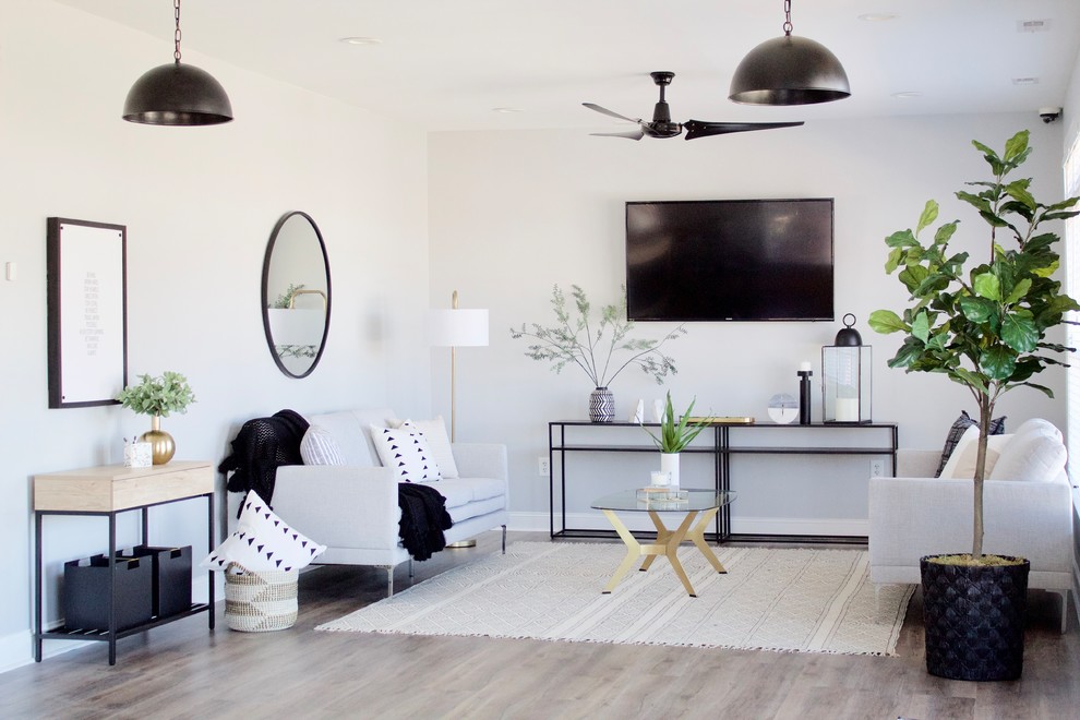 Foto di un soggiorno moderno aperto e di medie dimensioni con pareti grigie, pavimento in vinile, nessun camino, TV a parete, sala formale e pavimento grigio