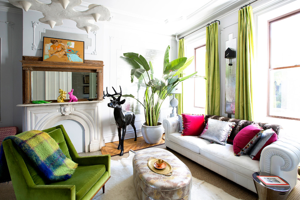This is an example of a bohemian living room in New York with white walls, medium hardwood flooring and brown floors.