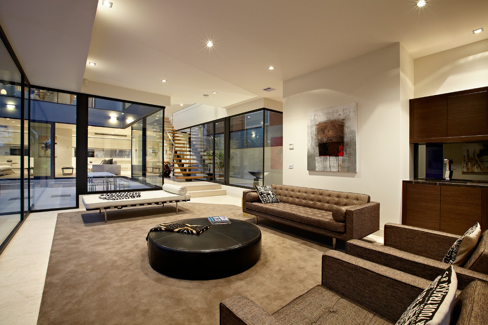Expansive contemporary living room in Melbourne with white walls.