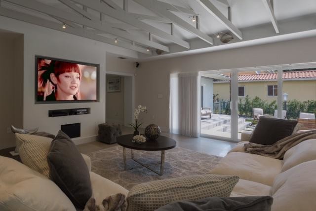 Example of a mid-sized trendy loft-style marble floor and beige floor living room design in Miami with gray walls and a media wall