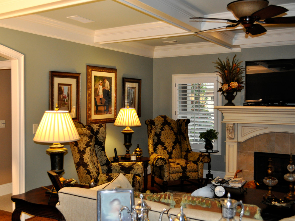 Example of a large classic formal and enclosed dark wood floor and brown floor living room design in Atlanta with green walls, a standard fireplace, a plaster fireplace and no tv