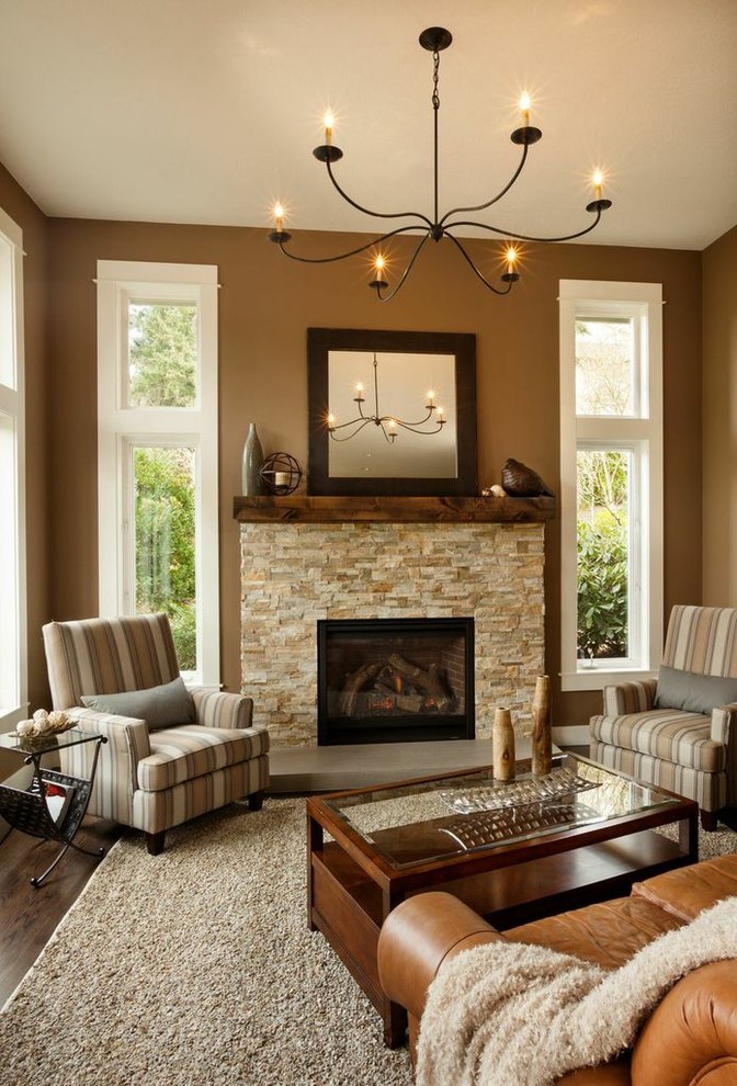 Photo of a medium sized classic open plan living room in Portland with brown walls, dark hardwood flooring, a standard fireplace, a stone fireplace surround and no tv.