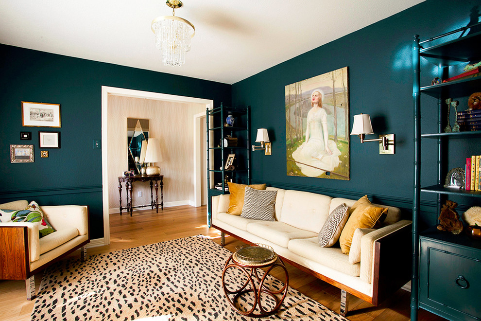 Eclectic enclosed medium tone wood floor living room photo in Austin with blue walls