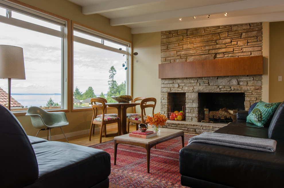 Example of a mid-sized 1960s open concept light wood floor living room design in Seattle with beige walls, a standard fireplace and a stone fireplace
