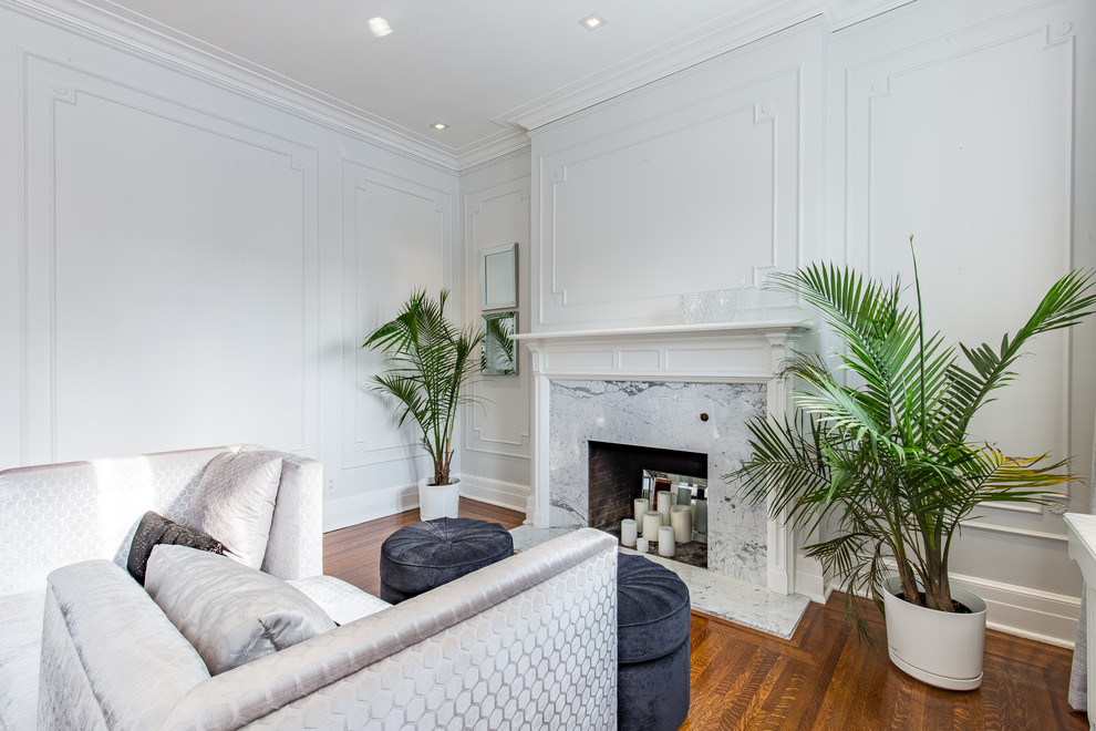 Inspiration for a transitional formal medium tone wood floor and brown floor living room remodel in Montreal with white walls, a standard fireplace, a brick fireplace and no tv