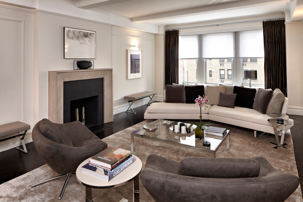 Photo of a contemporary living room in New York with beige walls, a standard fireplace and no tv.