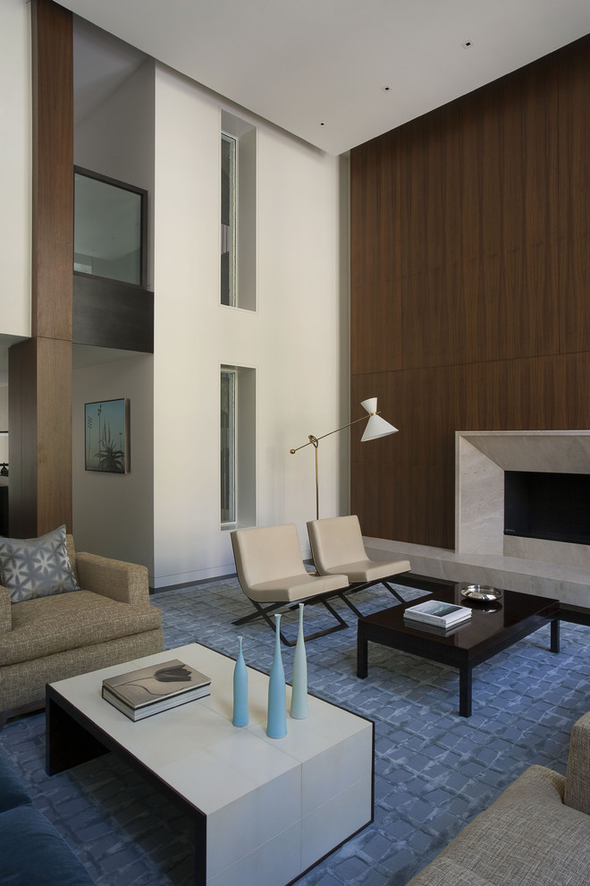 Expansive contemporary living room feature wall in New York with a standard fireplace.