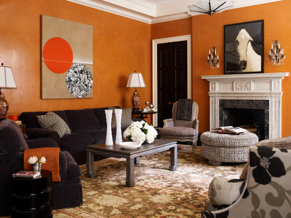 Example of a trendy living room design in New York with orange walls