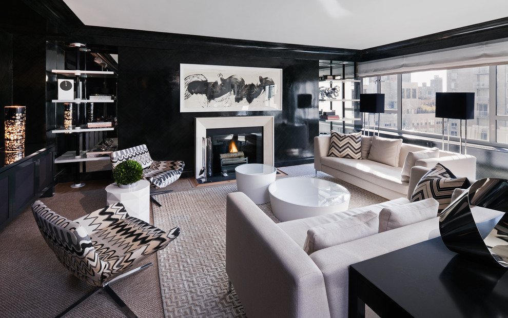 На фото: открытая гостиная комната в стиле модернизм с черными стенами, ковровым покрытием, стандартным камином и фасадом камина из дерева без телевизора с