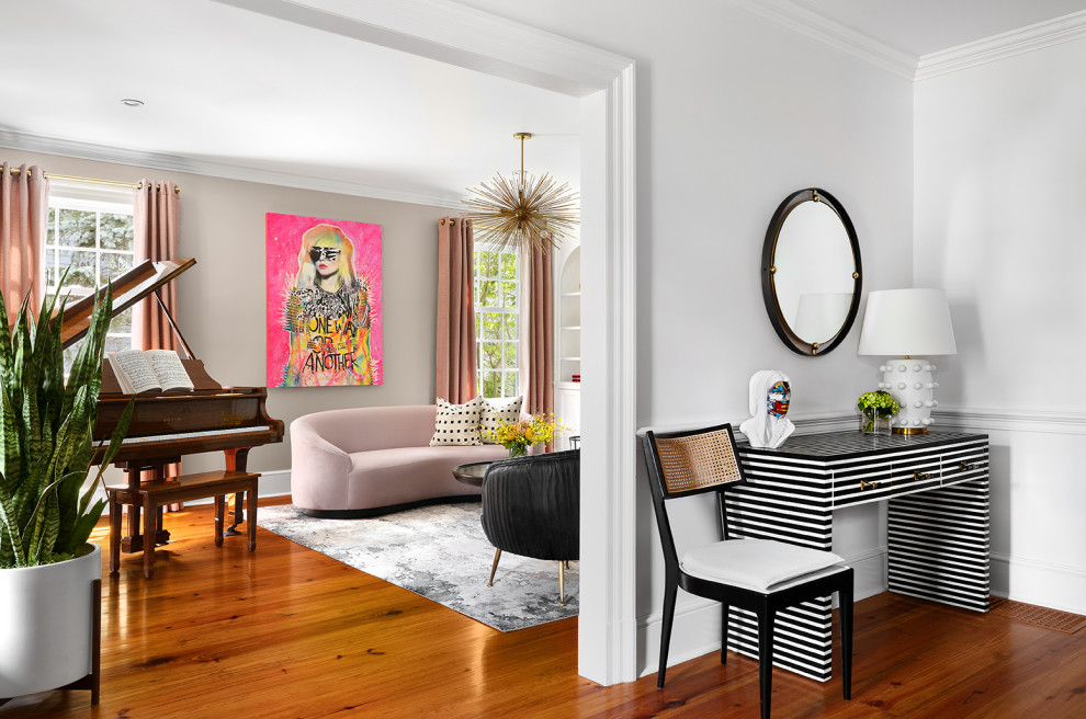 Inspiration for a medium sized modern formal enclosed living room in New York with pink walls, medium hardwood flooring and a standard fireplace.