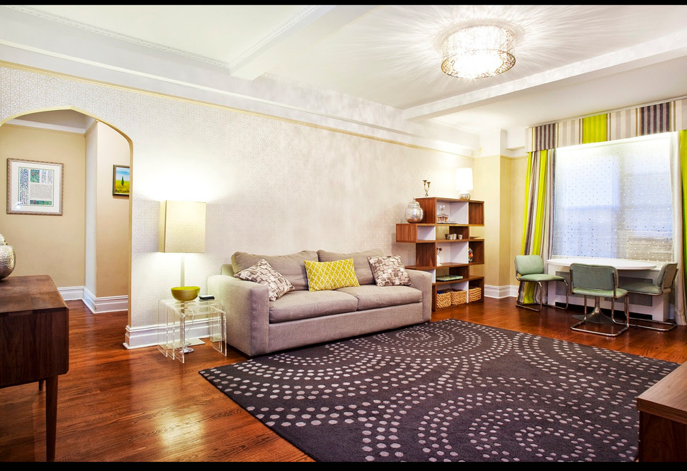 This is an example of a large eclectic enclosed living room in New York with yellow walls, medium hardwood flooring, no fireplace, no tv and brown floors.