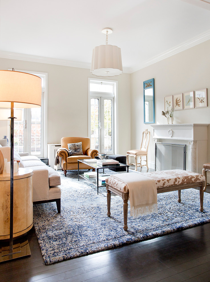 Example of a mid-sized classic formal dark wood floor living room design in New York with beige walls, a standard fireplace, a plaster fireplace and no tv