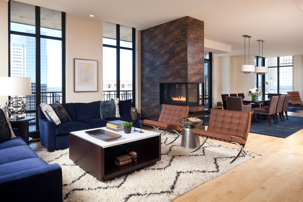 Example of a large trendy formal and open concept light wood floor living room design in Minneapolis with a two-sided fireplace, white walls and a tile fireplace