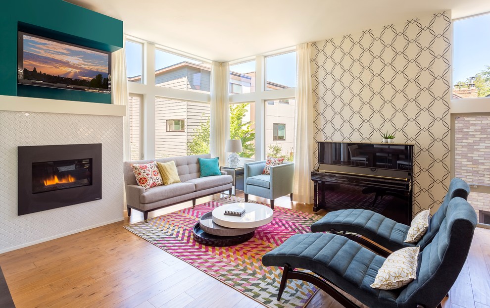 Design ideas for a contemporary grey and teal open plan living room feature wall in Seattle with beige walls, light hardwood flooring, a standard fireplace and a wall mounted tv.