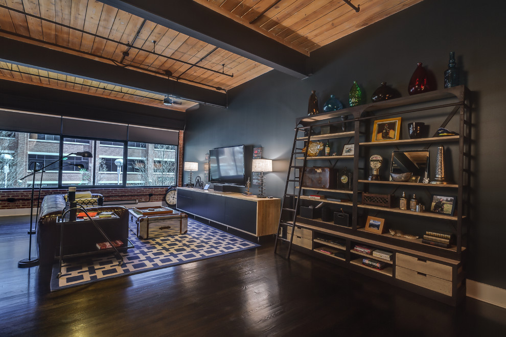 Inspiration for a large industrial open concept painted wood floor and black floor living room remodel in Charlotte with black walls, no fireplace and a wall-mounted tv