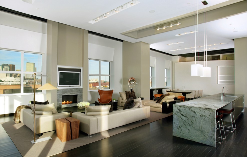 Expansive contemporary open plan living room in Boston with beige walls.
