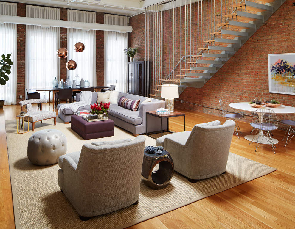 Photo of a large contemporary open plan living room in Chicago with medium hardwood flooring, brown walls, brown floors and feature lighting.
