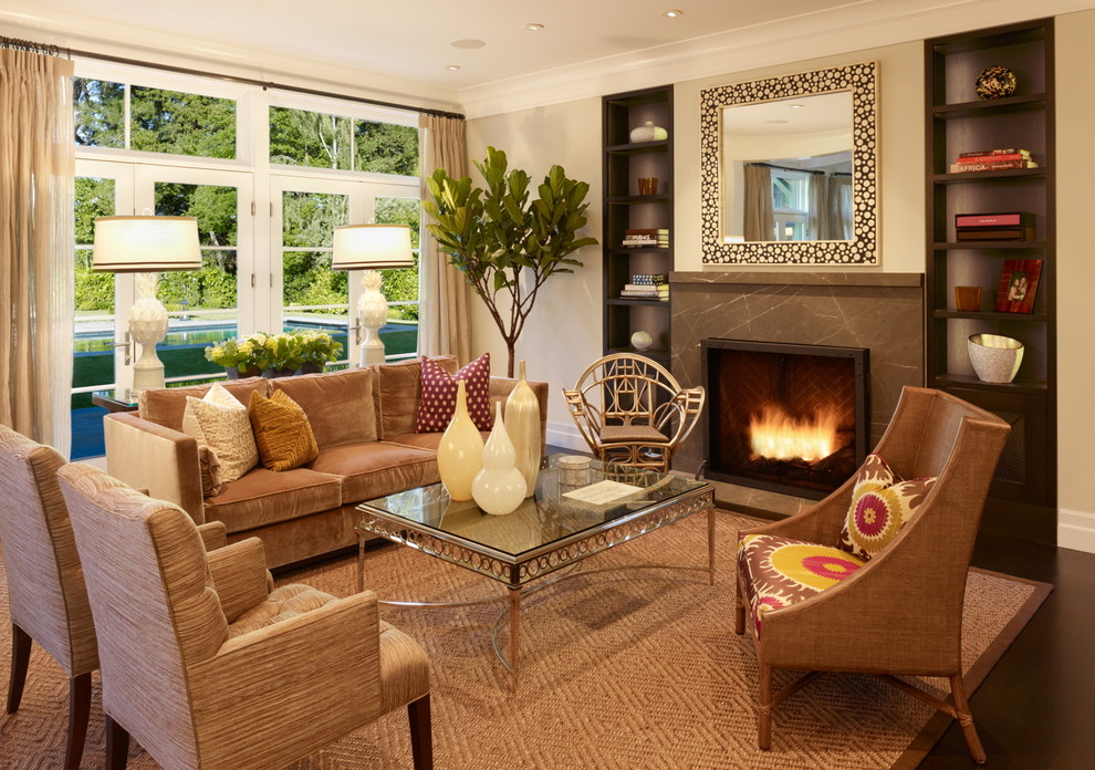 Example of a classic living room design in San Francisco with beige walls and a standard fireplace