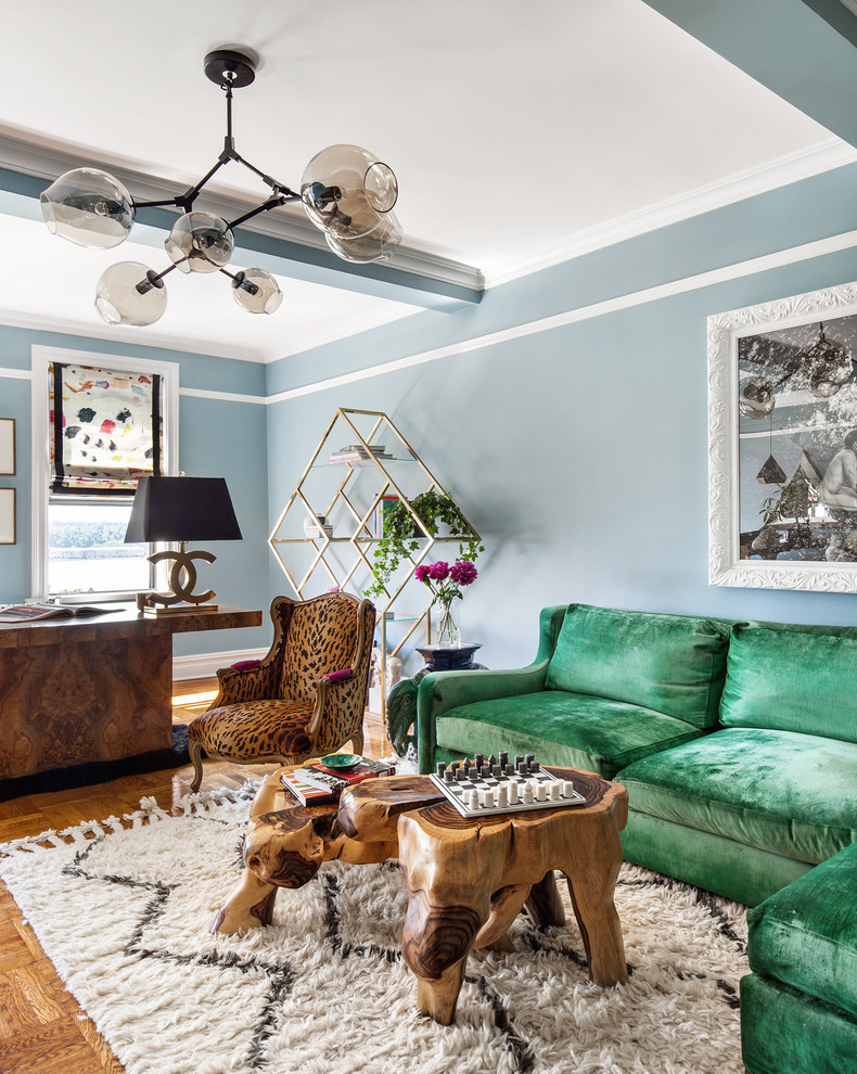 Living room - mid-sized eclectic formal and enclosed medium tone wood floor and brown floor living room idea in New York with blue walls and no tv