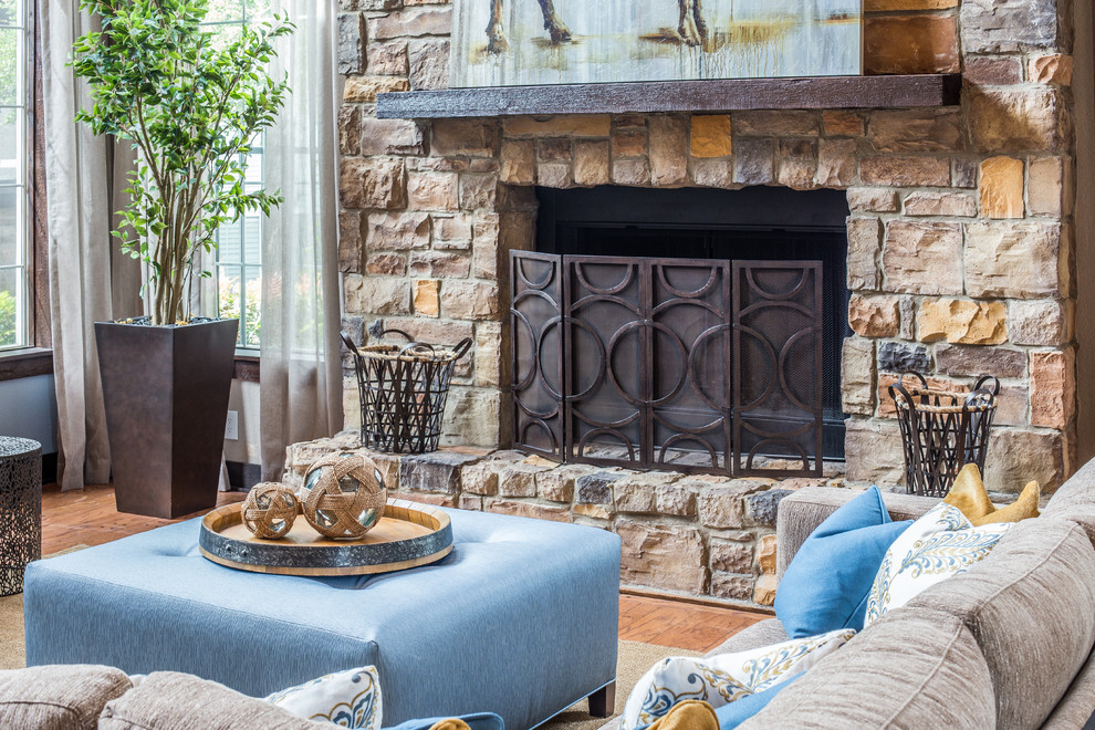 Photo of a rustic formal living room in Denver with beige walls, light hardwood flooring, a standard fireplace and a stone fireplace surround.