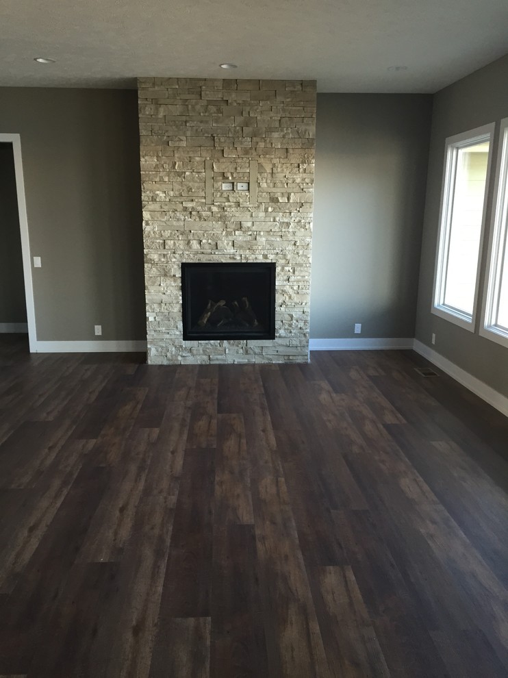 This is an example of a classic living room in Omaha with dark hardwood flooring and brown floors.