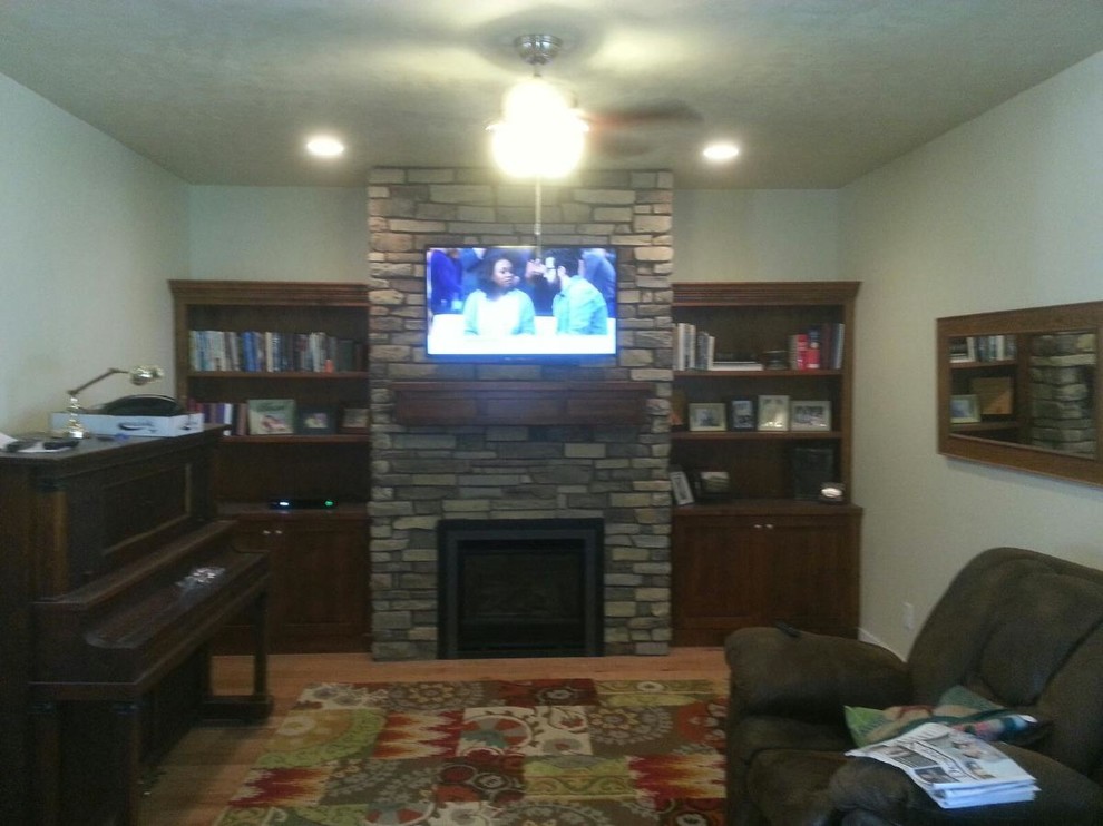 Mid-sized elegant light wood floor living room photo in Salt Lake City with a standard fireplace and a stone fireplace