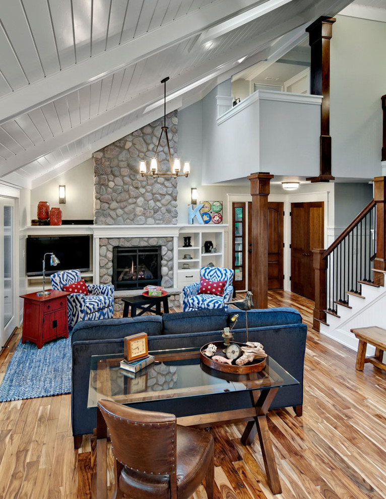 Large rustic living room in Minneapolis with white walls, a standard fireplace and a stone fireplace surround.