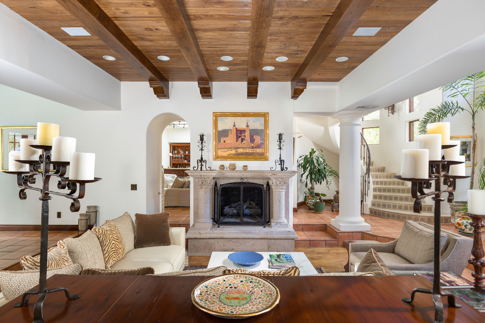 Inspiration for a mid-sized mediterranean enclosed living room remodel in Las Vegas with white walls, a standard fireplace, a stone fireplace and no tv