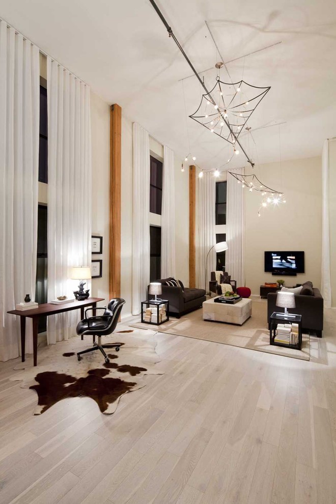 Example of an eclectic light wood floor and beige floor living room design in Los Angeles with beige walls