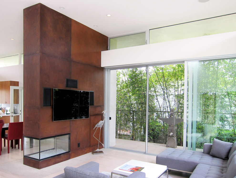 This is an example of a modern living room in Los Angeles with a two-sided fireplace.