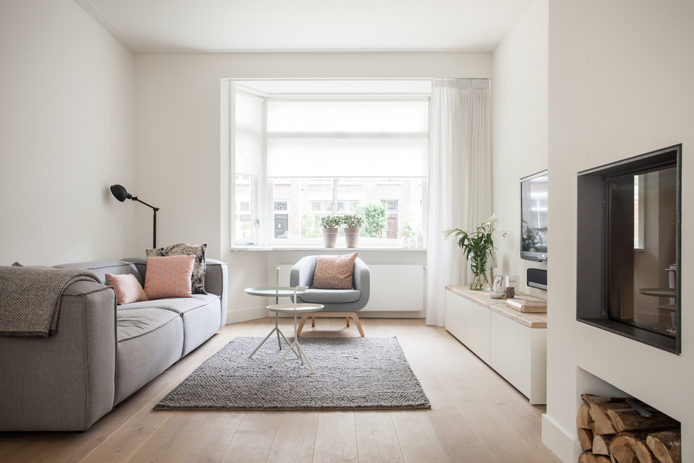 Design ideas for a scandinavian living room in Amsterdam with feature lighting.
