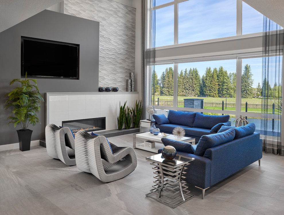 Großes Modernes Wohnzimmer im Loft-Stil mit grauer Wandfarbe, Keramikboden, Kamin, gefliester Kaminumrandung, Multimediawand und grauem Boden in Edmonton