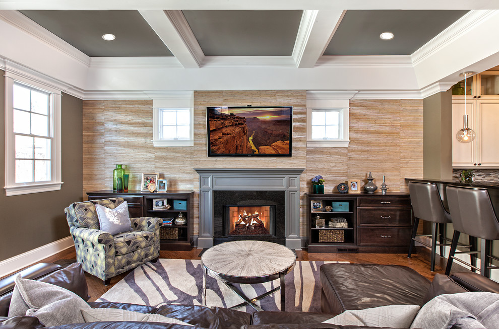 This is an example of a medium sized classic living room in Chicago with grey walls, medium hardwood flooring, a standard fireplace, a wooden fireplace surround and a wall mounted tv.