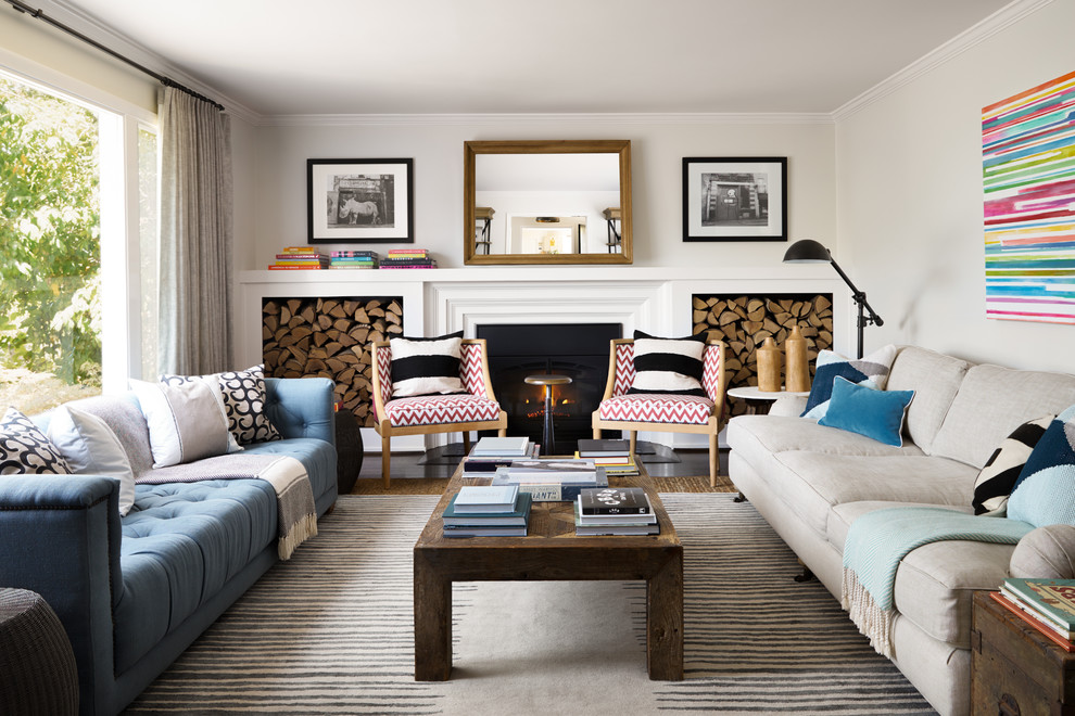 На фото: парадная, изолированная гостиная комната в стиле неоклассика (современная классика) с стандартным камином и синим диваном без телевизора с