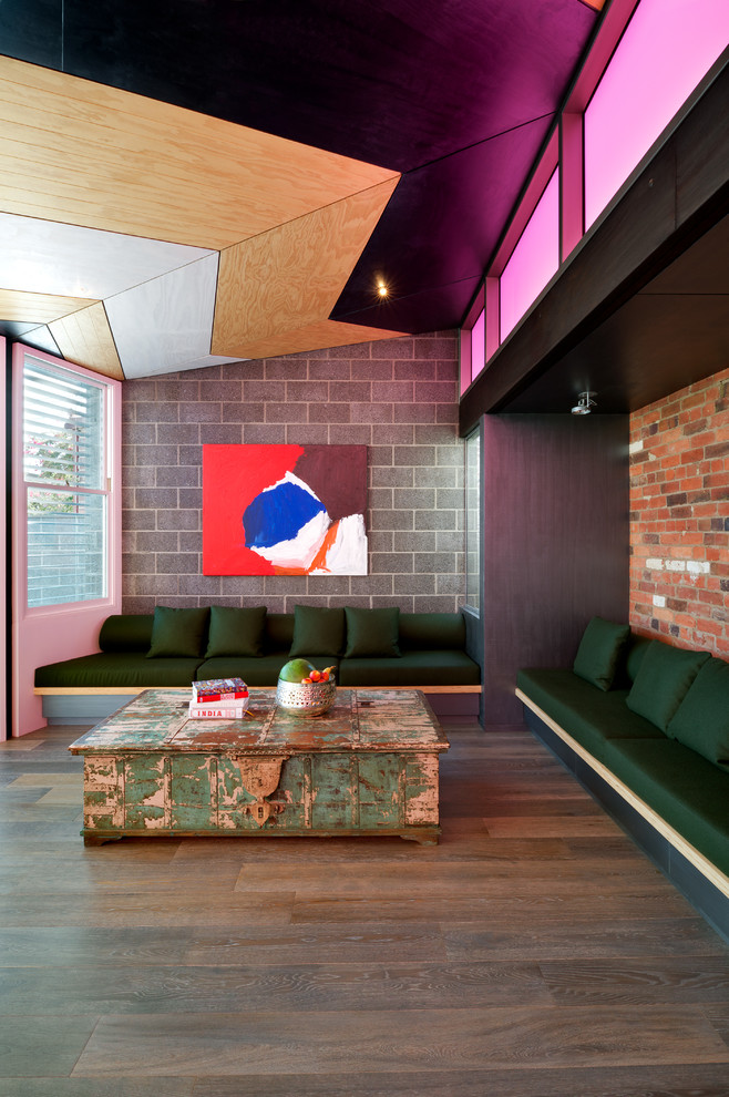 Large trendy open concept medium tone wood floor living room photo in Melbourne with multicolored walls