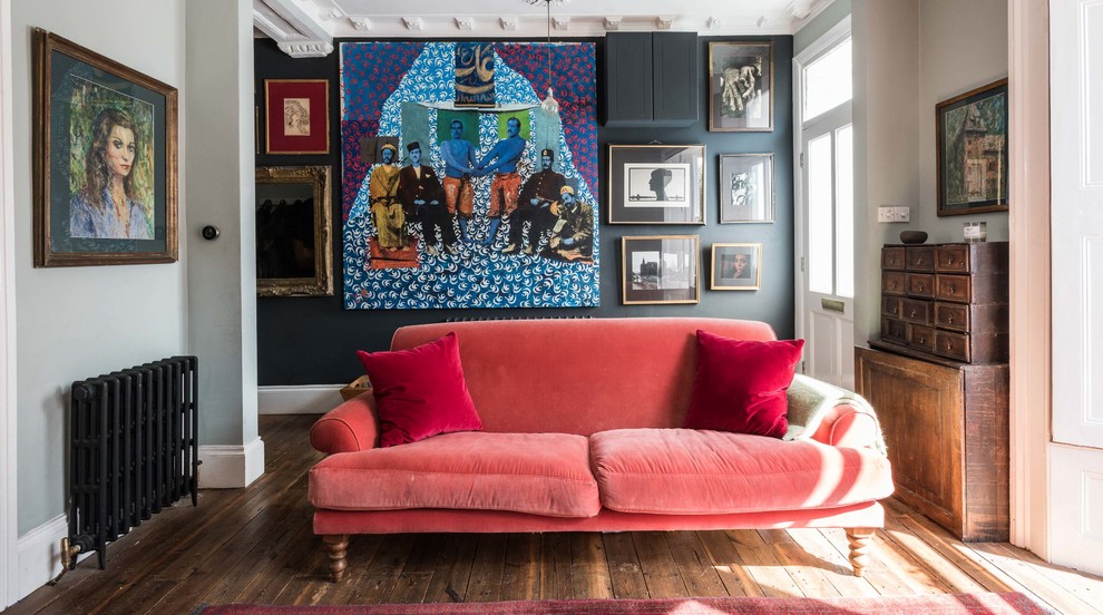 Eclectic open concept dark wood floor living room photo in London with black walls