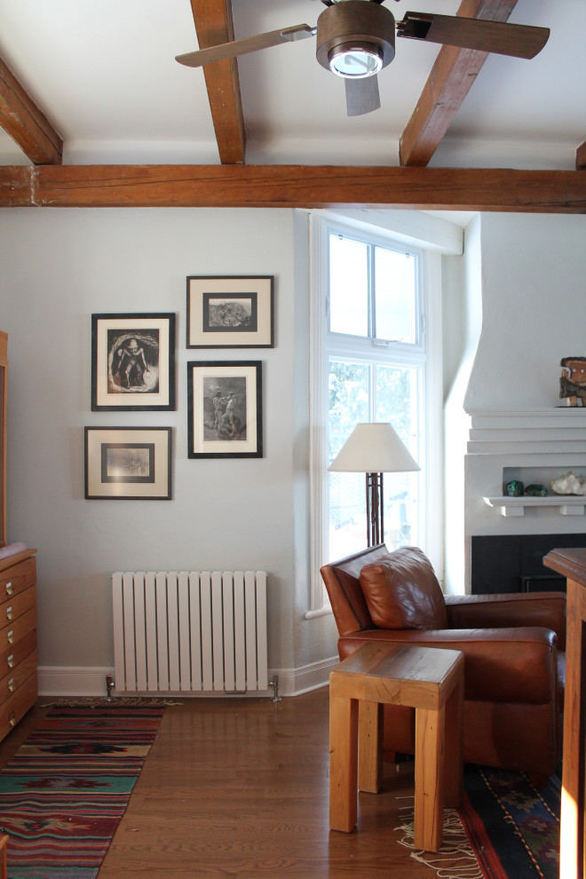 Inspiration for a medium sized victorian enclosed living room in Montreal with blue walls, medium hardwood flooring, a standard fireplace, a freestanding tv and brown floors.